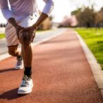 Athlete consulting orthopaedic surgeon about minimally invasive sports injury treatment and faster recovery