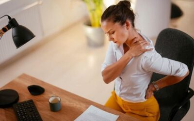 Young office professional suffering from neck and back pain due to prolonged sitting and poor posture at work