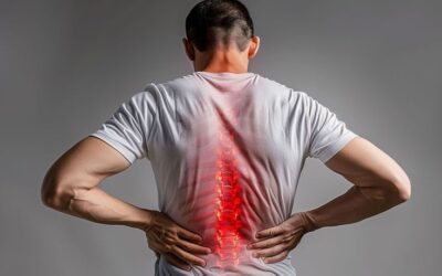 Office professional experiencing lower back pain while sitting at a desk due to prolonged working hours